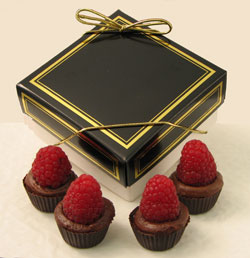 Raspberry Royale | 4-piece box - Dark chocolate is blended with dark chocolate ganache and European raspberry preserves to create our newest confection.  Offered in a chocolate cup and topped with a fresh raspberry.  Packed in a four-piece box and personalized with your choice of message on a minimum order of fifty boxes.