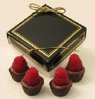 Raspberry Royale | 4-piece box - Dark chocolate is blended with dark chocolate ganache and European raspberry preserves to create our newest confection.  Offered in a chocolate cup and topped with a fresh raspberry.  Packed in a four-piece box and personalized with your choice of message on a minimum order of fifty boxes.