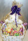 Easter Basket - Our large deluxe Easter basket is filled with a twelve-piece box of our Signature Chocolates and packed full with wrapped Easter candies and smaller Easter plush bunnies.  The basket is guarded over by a large Easter bunny.  Packed in a clear bag with a large bow.