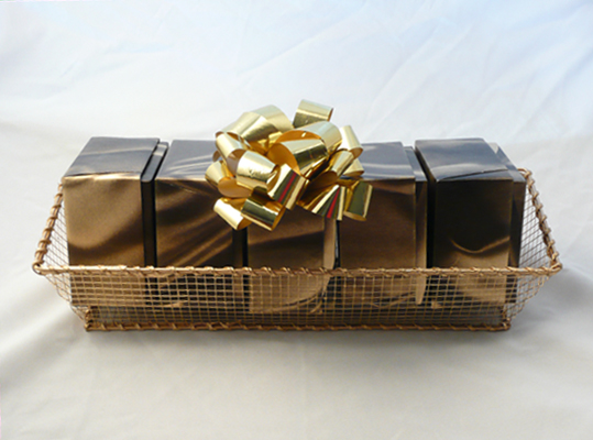 Leaning Tower of Five Confections - Matching gold boxes filled with cajun nut mix; chocolate covered peanuts, assorted flavored gummy bears; chocolate covered pretzels, and our special chocolate covered caramel corn. This is a beautiful presentation in a gold mesh basket. Shrink-wrapped with a decorative bow.