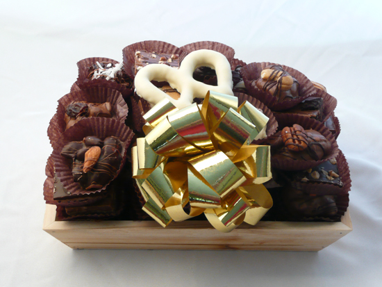 Chocolate Tray Basket | 3 Lb. - Flat wooden basket filled with decorative straw and layered with a seventy-five assortment of fresh delectable Chocolate Octopus Signature Chocolates. Shrink-wrapped with a large bow help to complete a very visually edible gift. Three-pound basket. 