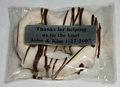 Bavarian Pretzel | Printed Message - A large Bavarian pretzel, dipped in kettles of pure chocolate, and then wrapped in a clear cello bag and labeled with a personalized message.  The pretzel is available in milk, dark or white chocolate, with contrasting chocolate drizzle.  A favorite message is "Thank you for helping us tie the knot.  Love Jack & Jill."  Price includes printing with a minimum of 25 pieces.