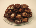 Hostess Platter | Chocolates - A hostess gift that is well received and enjoyed.  Twenty-five pieces of our best selling assorted chocolates are layered on a round tray. Shrink wrapped with a decorative bow on top.